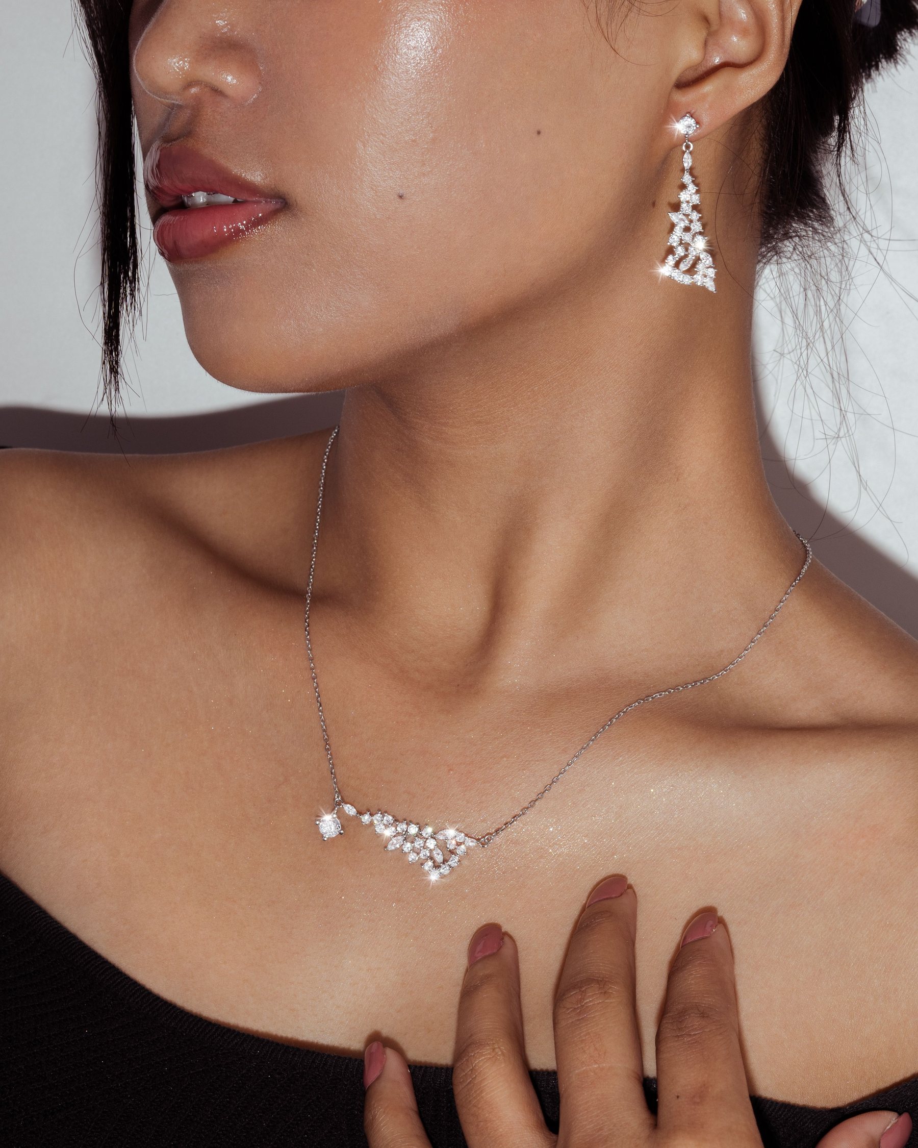 Model wearing a short crystal necklace and matching earrings