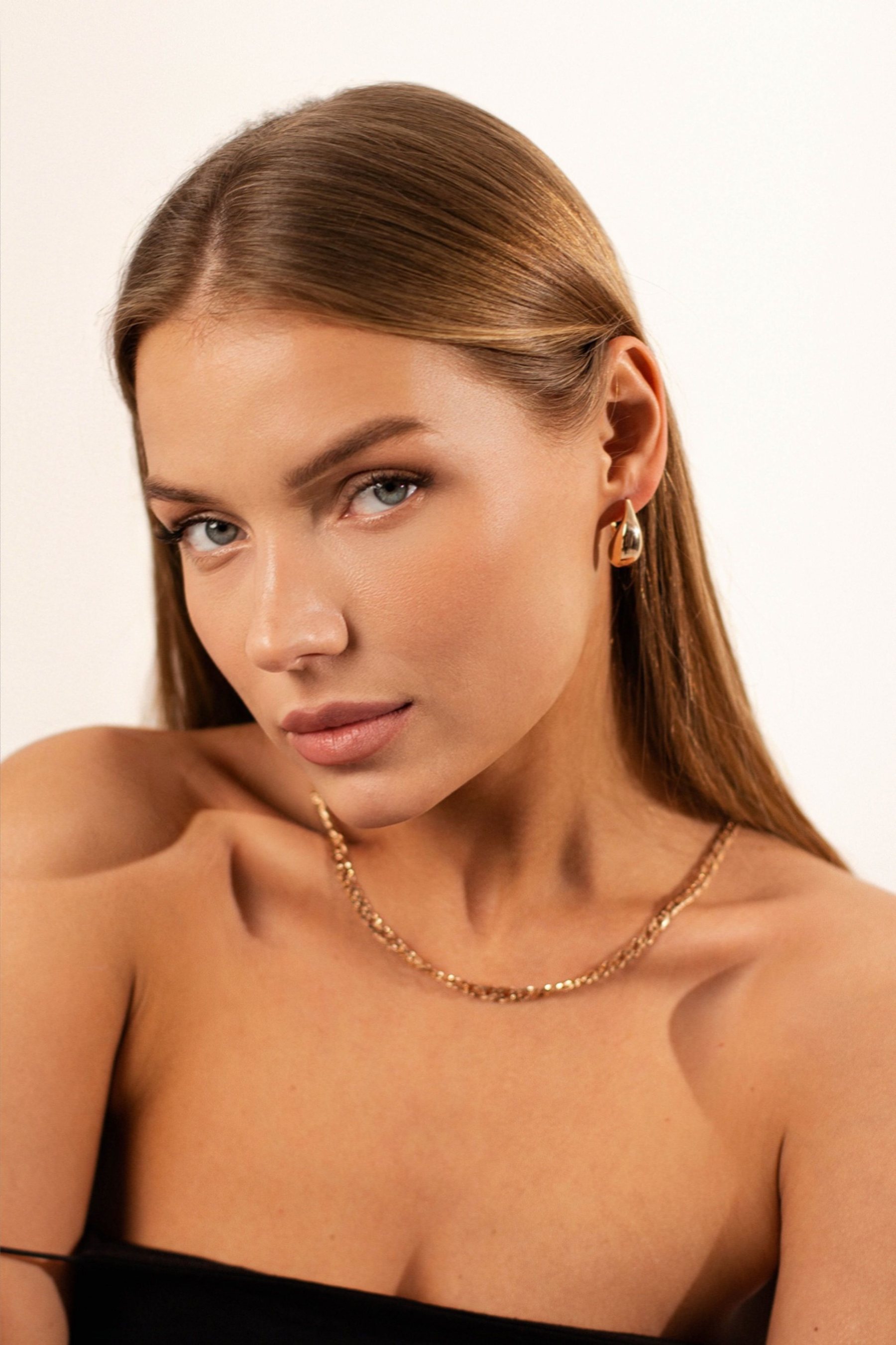 Model wearing modern gold jewellery
